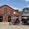 a person and a dog sitting on a restaurant brick patio - EDE downtown Frederick MD apartments 