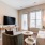 living room couch and chair by coffee table and tv EDE downtown Frederick MD apartments